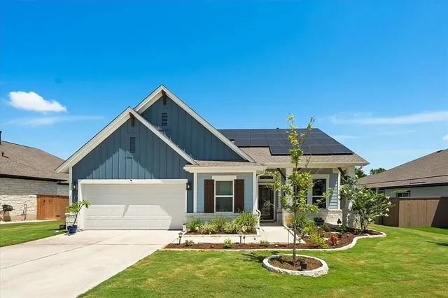 a front view of a house with a yard patio and fire pit