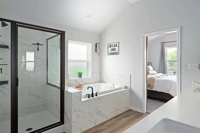 a spacious bathroom with a double vanity sink a mirror and a bathtub