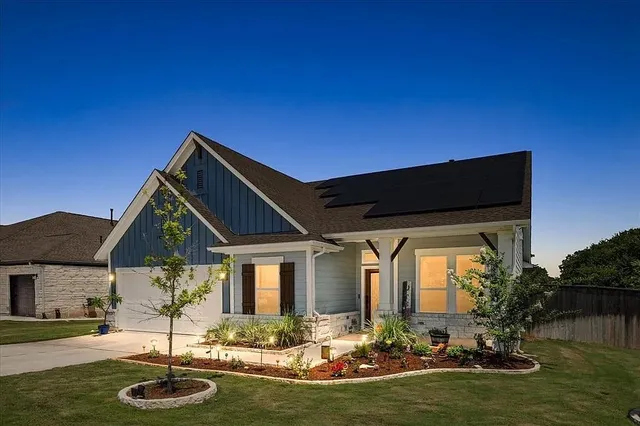 a front view of house with yard and lake view