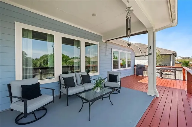 a view of a chairs and table in patio with a swimming pool