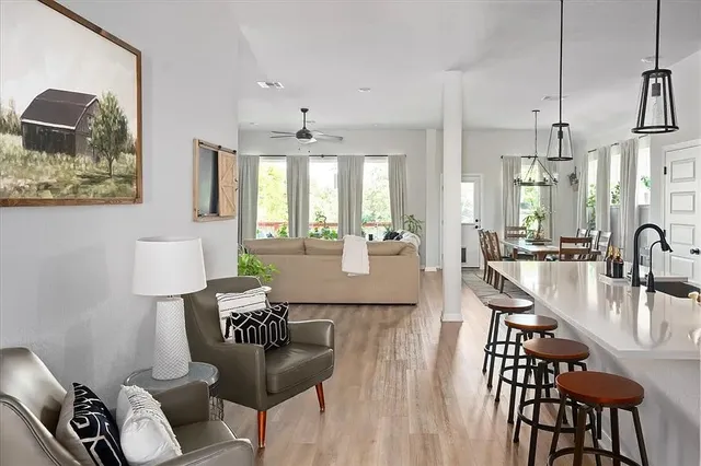 a living room with furniture and wooden floor