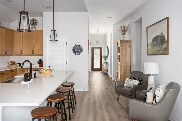 a living room with furniture and a wooden floor