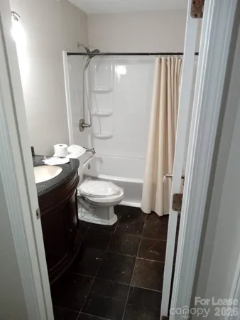 a bathroom with a sink a toilet a shower and a mirror