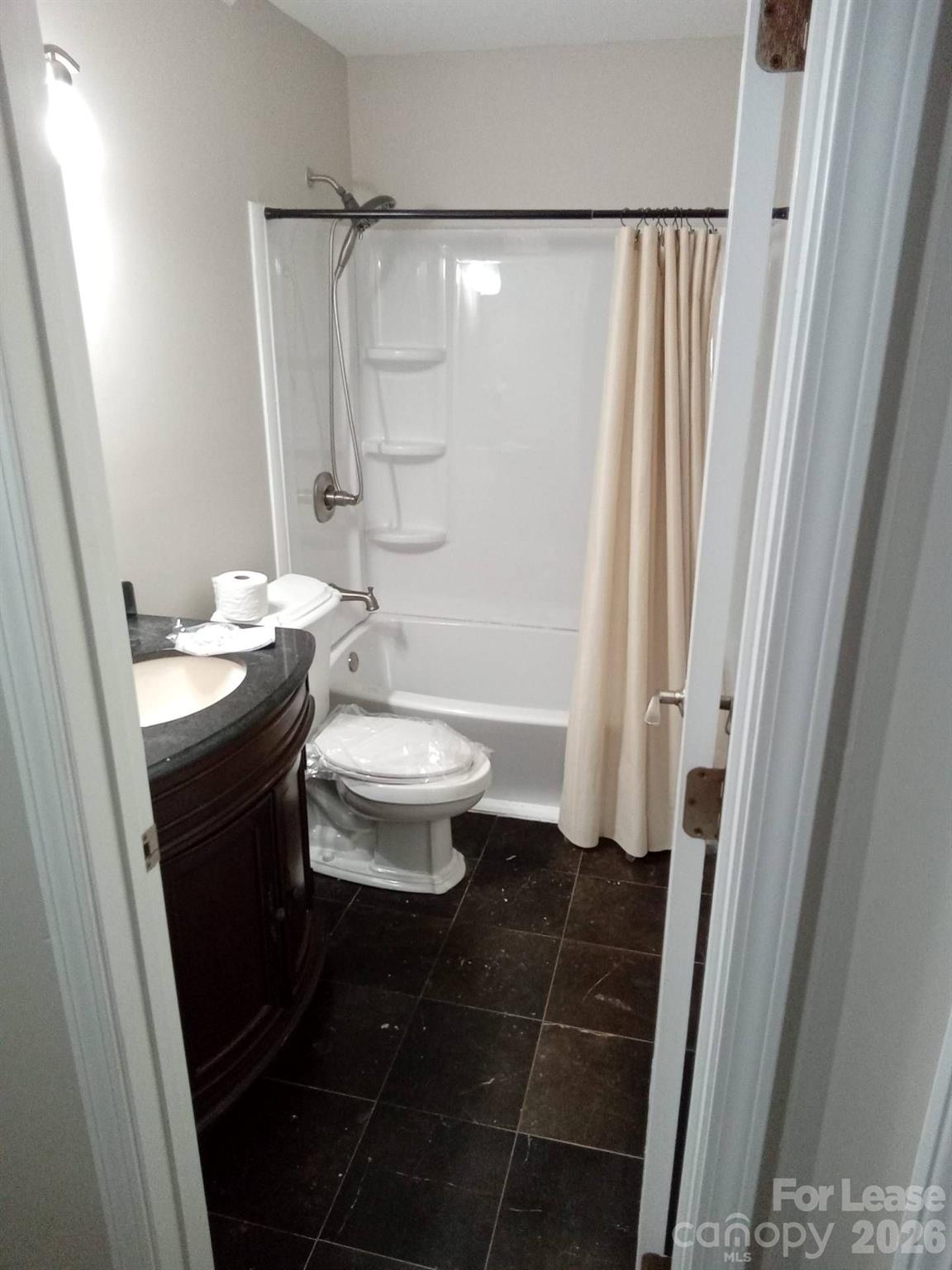 764 West Franklin Street Monroe, NC 28112 - Photo 4 of 10 a bathroom with a sink a toilet a shower and a mirror