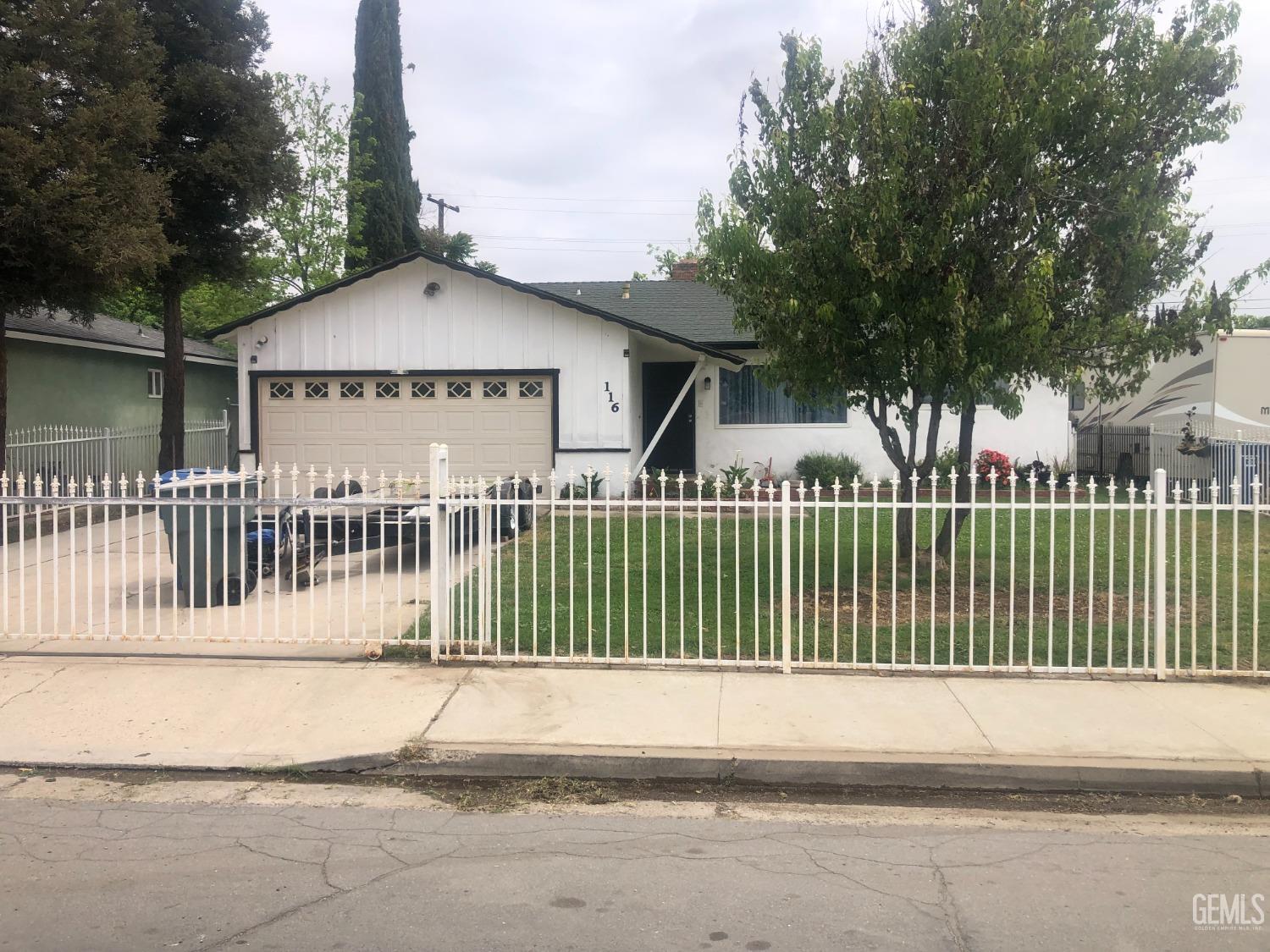 a view of a house with a wooden fence