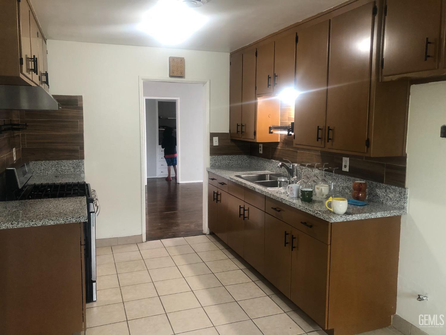 Undisclosed Address Bakersfield, CA 93308 - Photo 2 of 11 a kitchen with granite countertop cabinets and steel stainless steel appliances