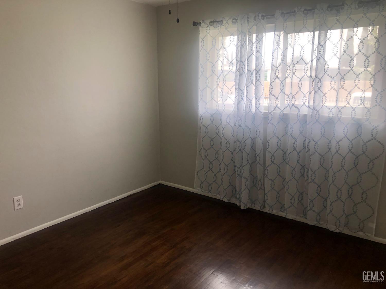 Undisclosed Address Bakersfield, CA 93308 - Photo 4 of 11 a view of wooden floor and windows in a room