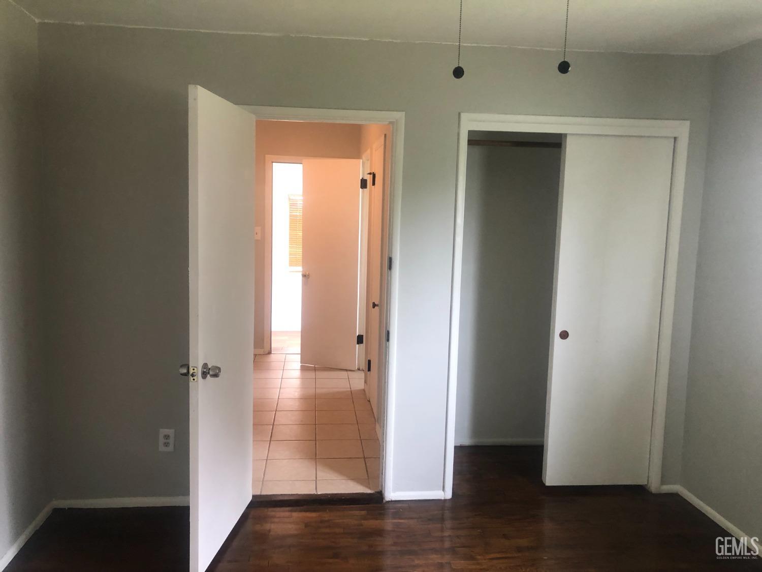 Undisclosed Address Bakersfield, CA 93308 - Photo 8 of 11 a view of a hallway with wooden floor