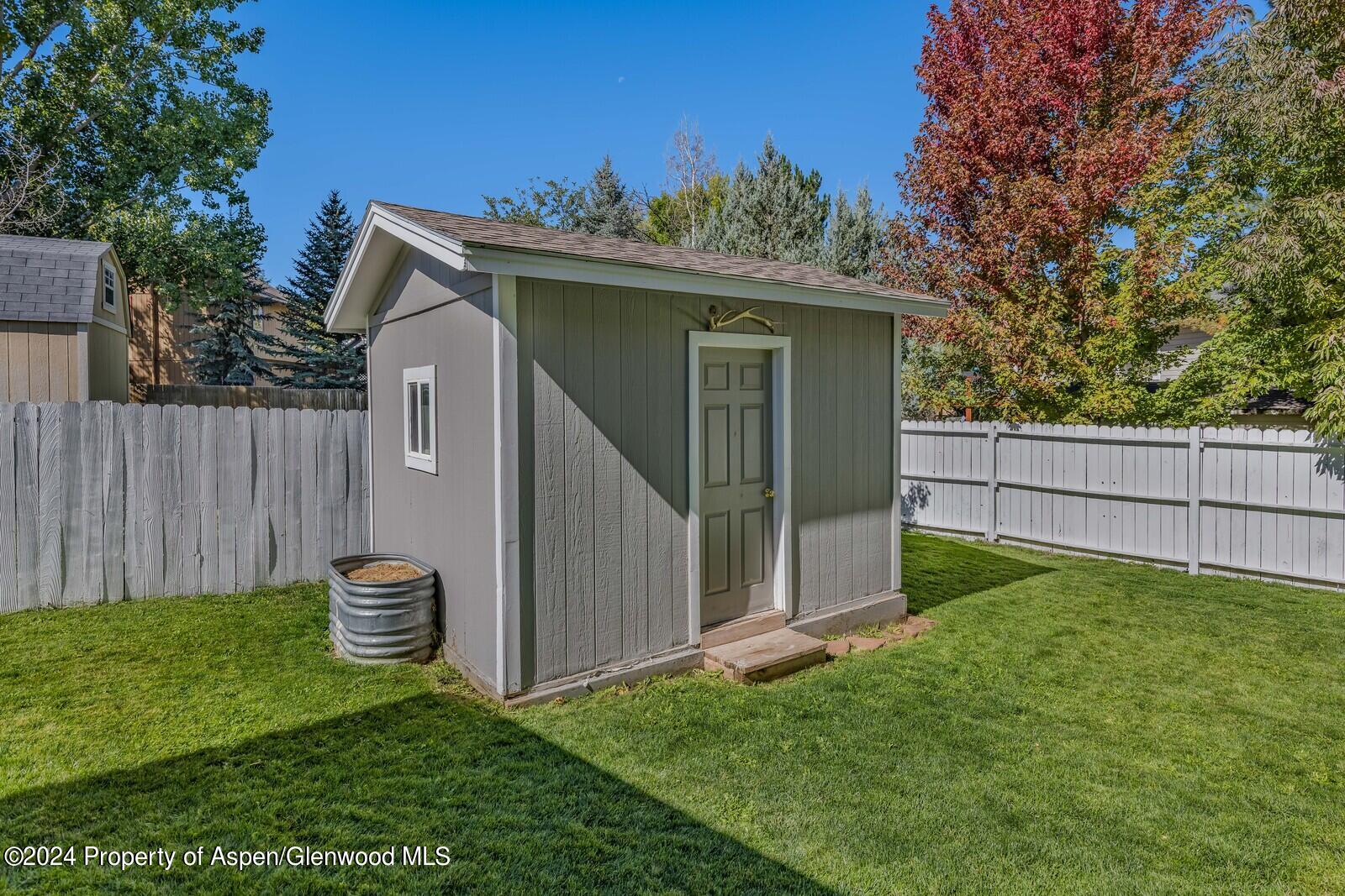 176 Rabbit Road Carbondale, CO 81623 - Photo 10 of 29 a view of a tiny house with a small yard and wooden fence