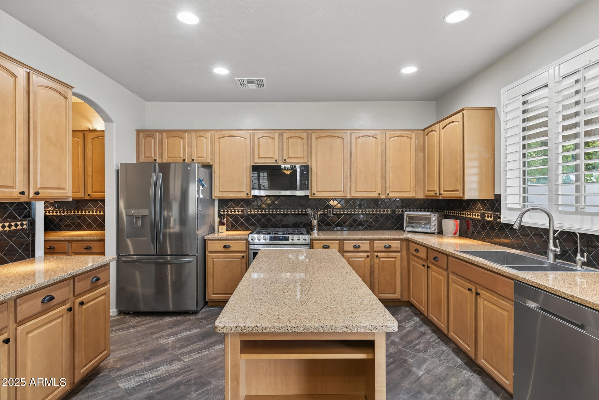 28305 North Desert Native Street San Tan Valley, AZ 85143 - Photo 13 of 81 a kitchen with refrigerator cabinets and wooden floor