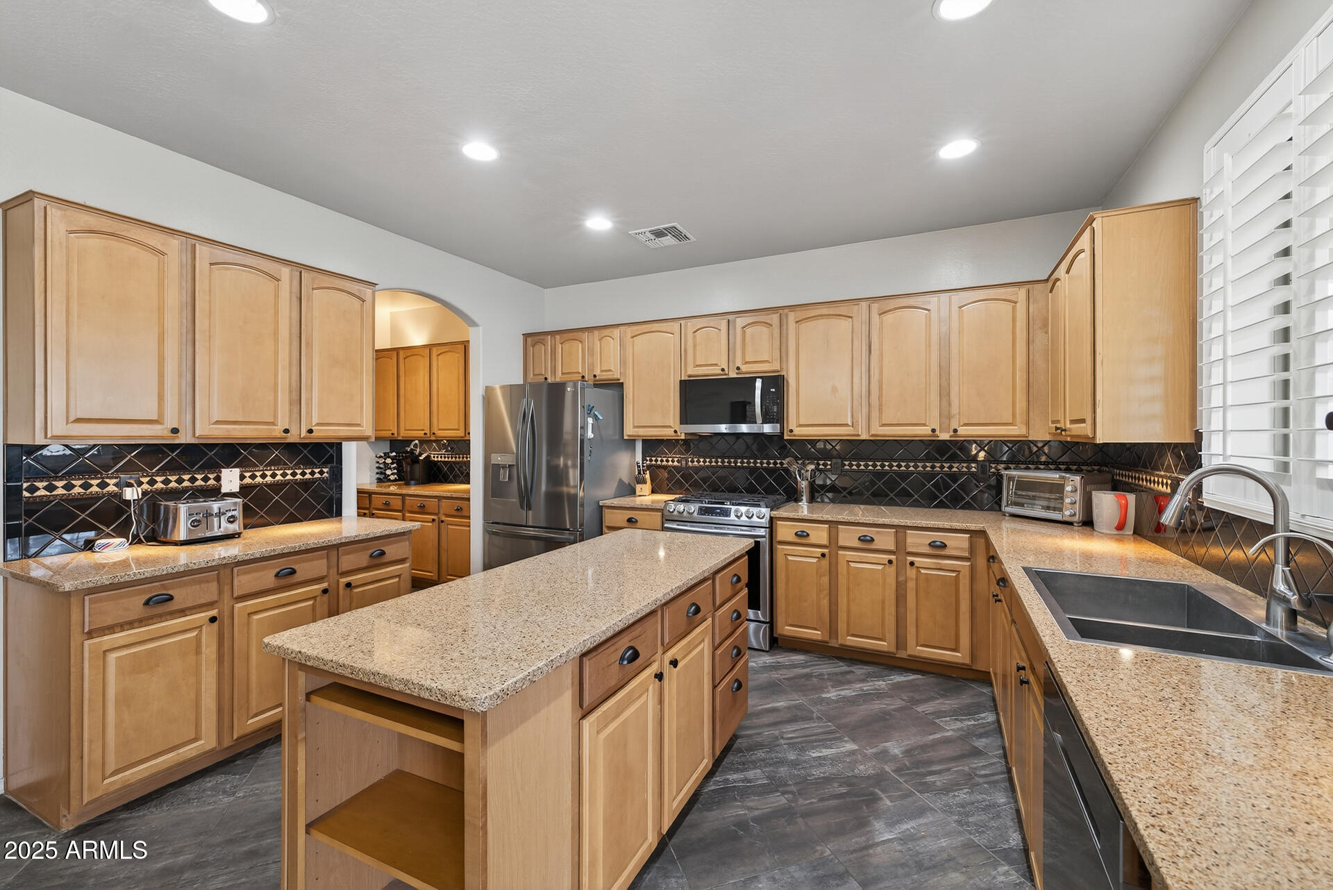 28305 North Desert Native Street San Tan Valley, AZ 85143 - Photo 14 of 81 a kitchen with a sink stove and cabinets