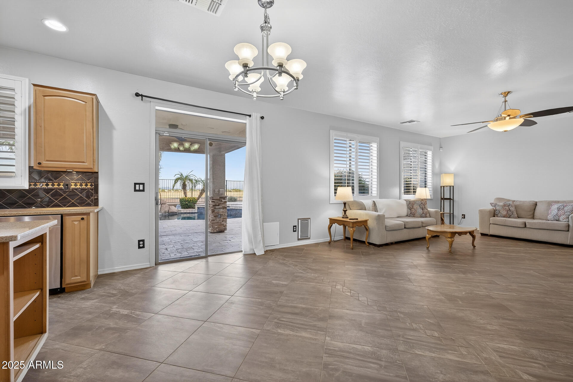 28305 North Desert Native Street San Tan Valley, AZ 85143 - Photo 22 of 81 a living room with furniture and a chandelier