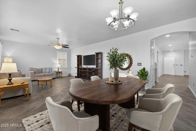 a bedroom with a bed and a flat screen tv with wooden floor