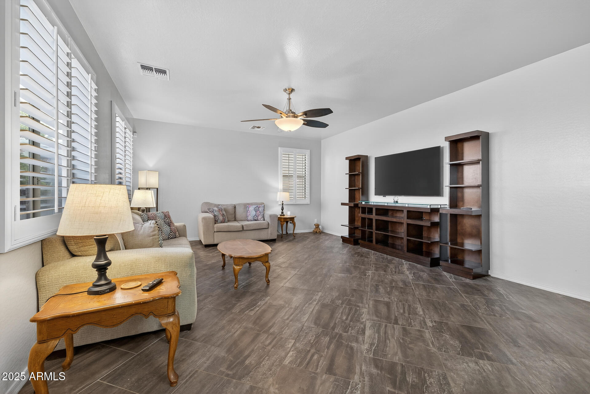 28305 North Desert Native Street San Tan Valley, AZ 85143 - Photo 27 of 81 a living room with furniture and a flat screen tv