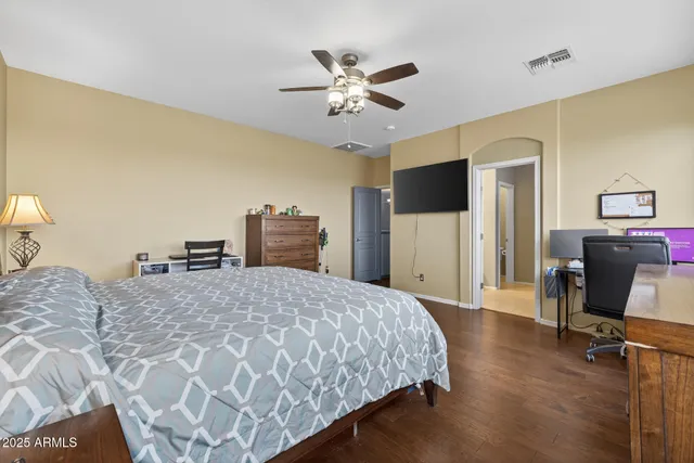 a view of an empty room with furniture and a window