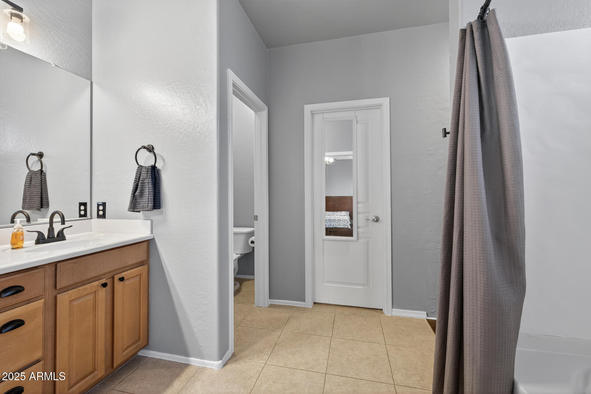 28305 North Desert Native Street San Tan Valley, AZ 85143 - Photo 35 of 81 a bathroom with a double vanity sink and a mirror