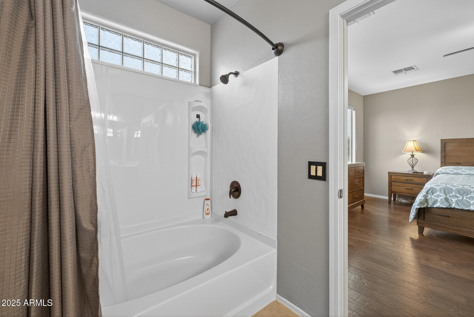 28305 North Desert Native Street San Tan Valley, AZ 85143 - Photo 36 of 81 a bathroom with a tub shower and hallway