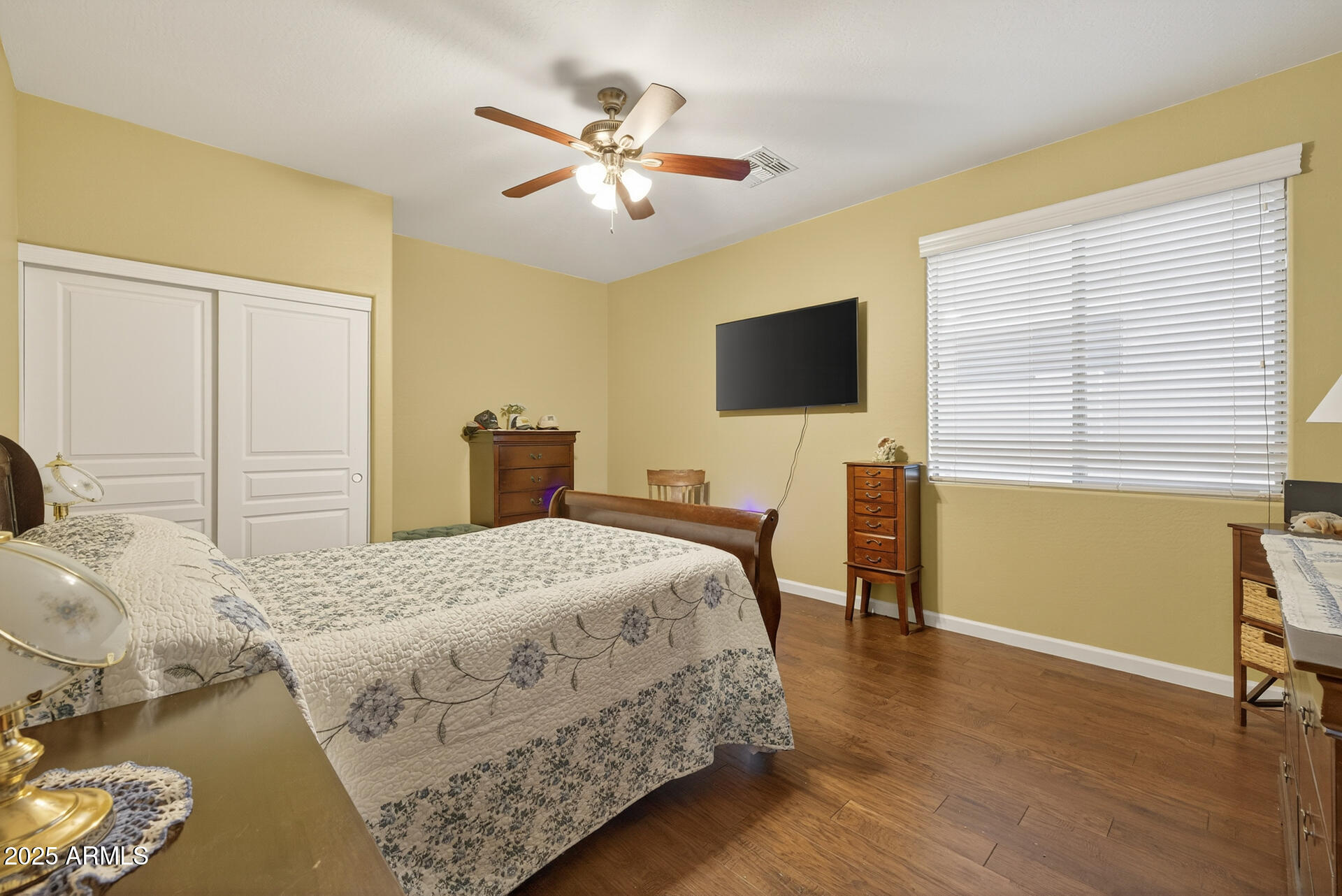 28305 North Desert Native Street San Tan Valley, AZ 85143 - Photo 37 of 81 a bedroom with a bed and a flat screen tv with wooden floor