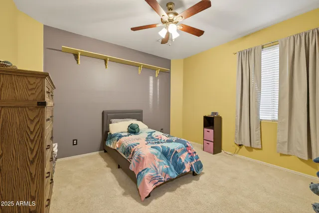 a view of a swimming pool with a yard and trees