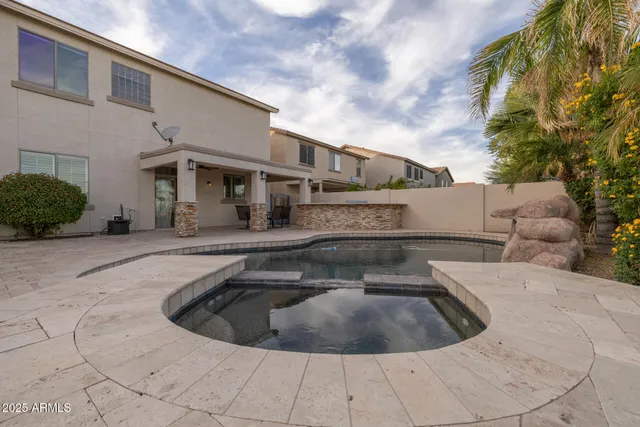 a swimming pool with outdoor seating and yard