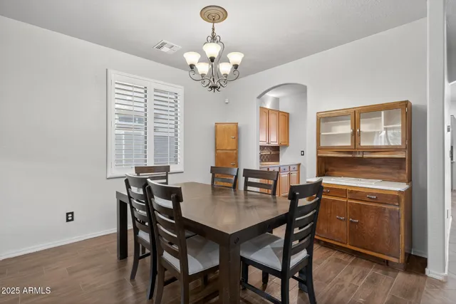 a view of a dining room with furniture and chandelier