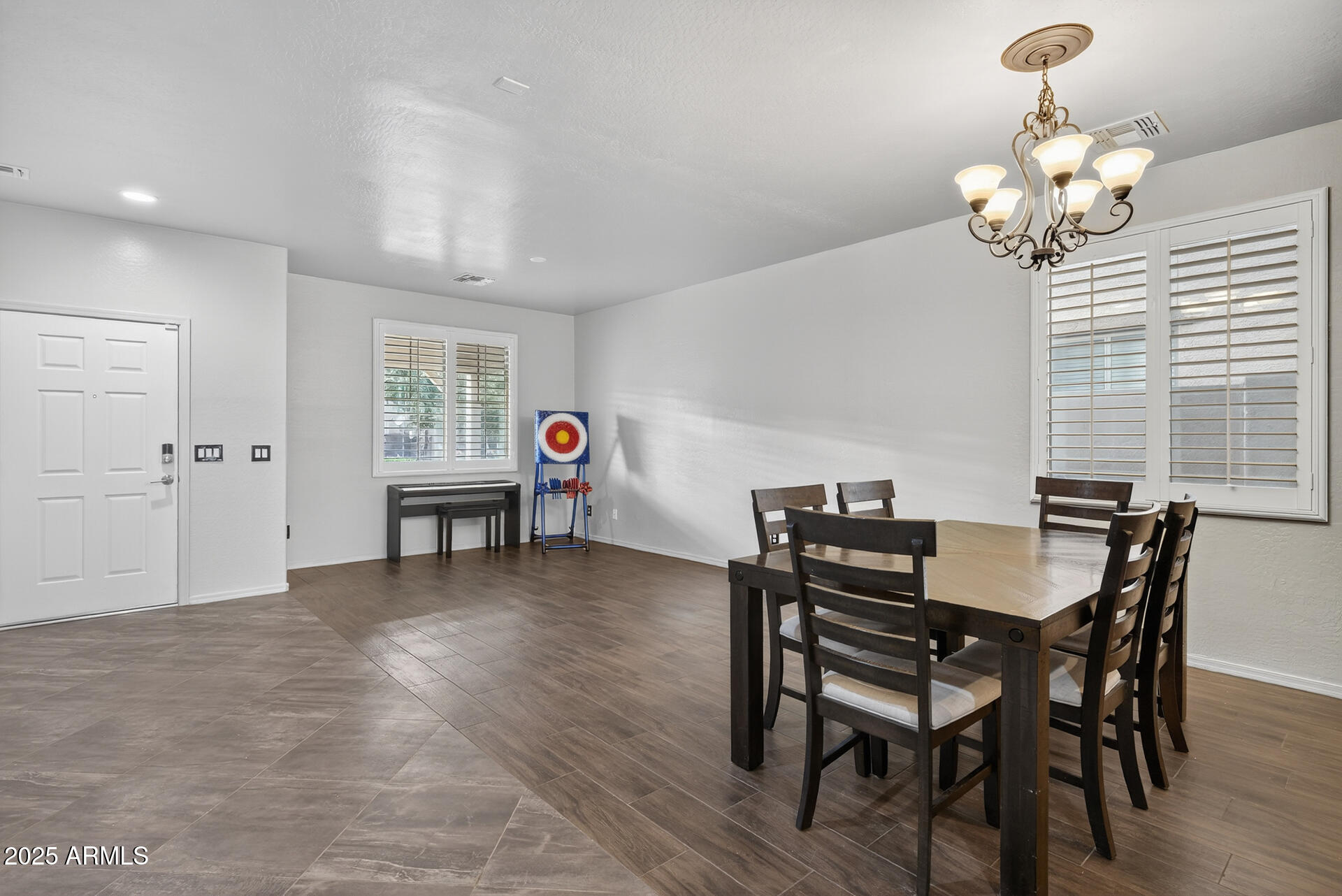 28305 North Desert Native Street San Tan Valley, AZ 85143 - Photo 9 of 81 a view of a dining room with furniture and wooden floor