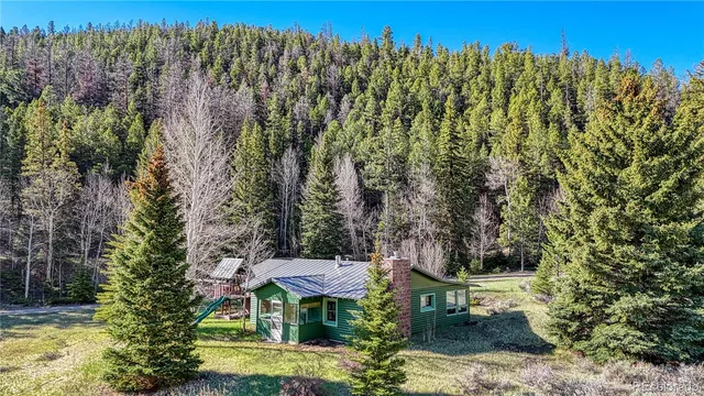 a view of a house with a patio and a yard