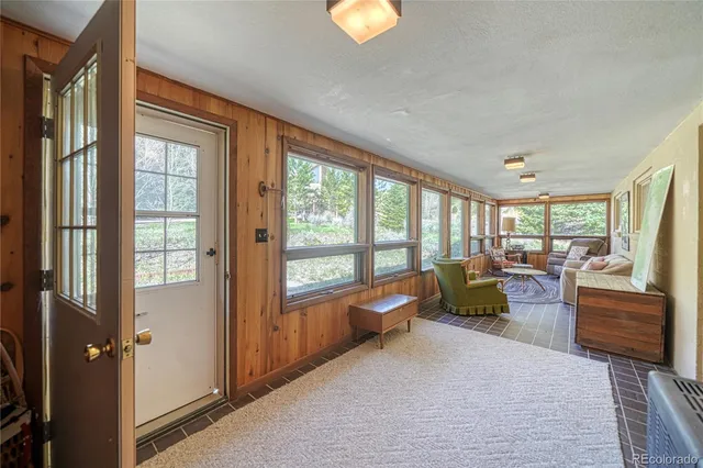 a living room with furniture and a lamp