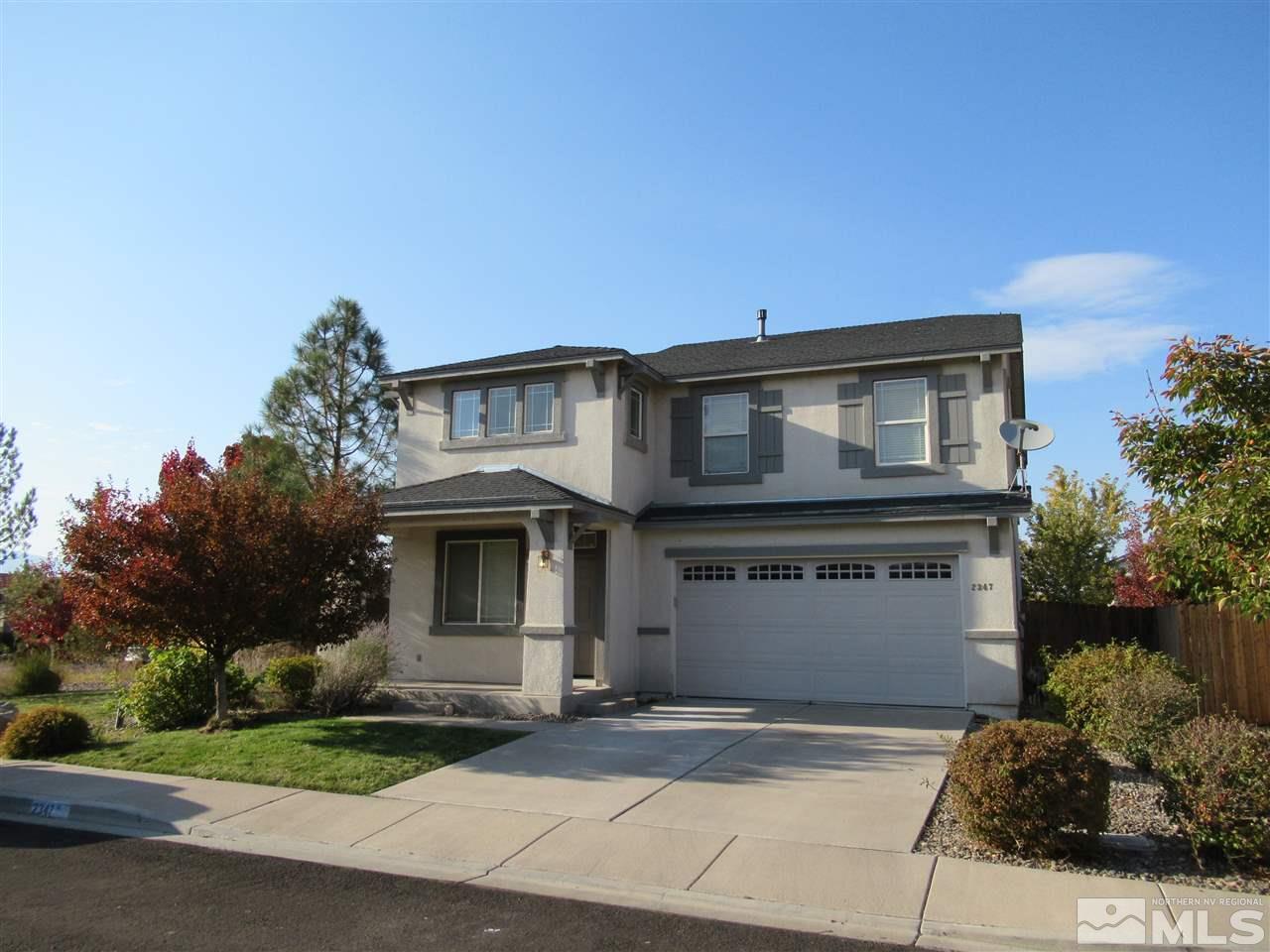 2347 Clementine Lane Reno, NV 89521 - Photo 1 of 19 a front view of a house with a garden