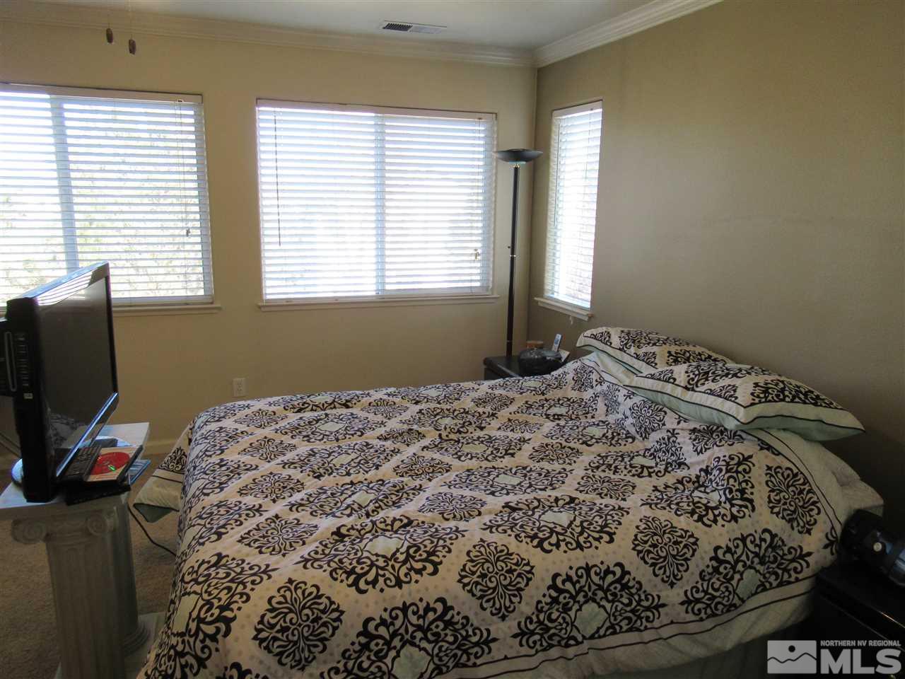 2347 Clementine Lane Reno, NV 89521 - Photo 13 of 19 a bed sitting in a bedroom next to a window
