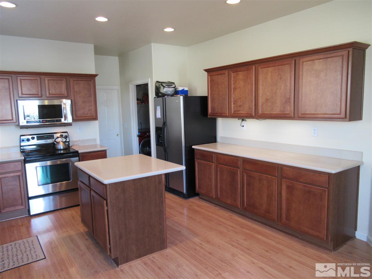 2347 Clementine Lane Reno, NV 89521 - Photo 8 of 19 a kitchen with stainless steel appliances wooden cabinets and granite counter tops