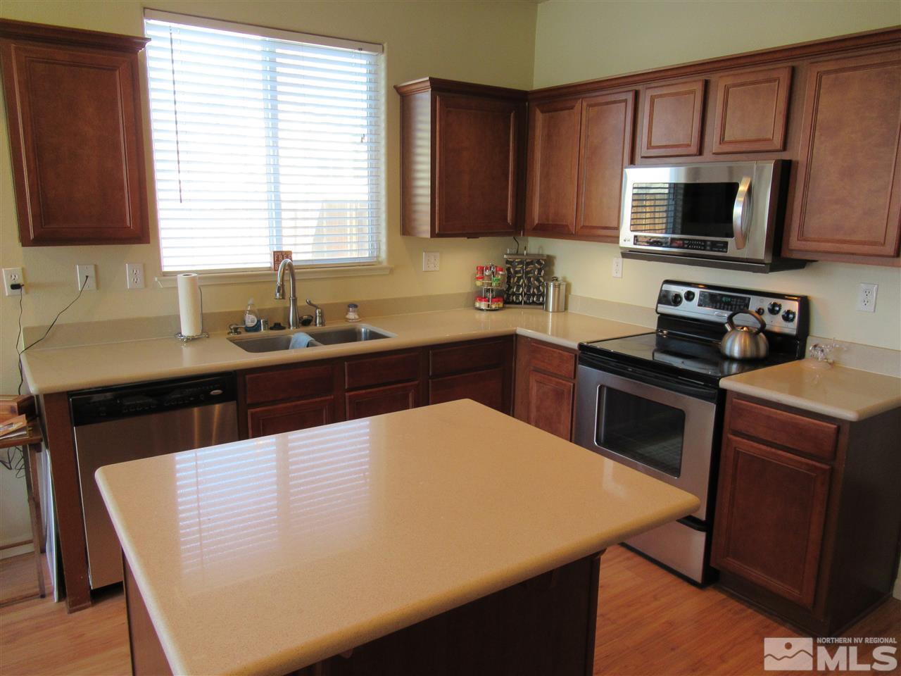 2347 Clementine Lane Reno, NV 89521 - Photo 9 of 19 a kitchen with a sink a microwave a stove and refrigerator