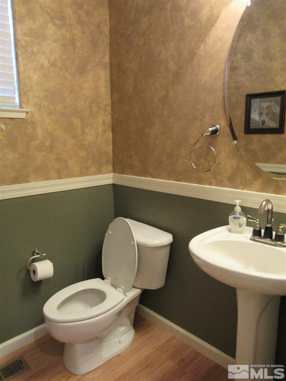 2347 Clementine Lane Reno, NV 89521 - Photo 10 of 19 a bathroom with a toilet a sink and mirror