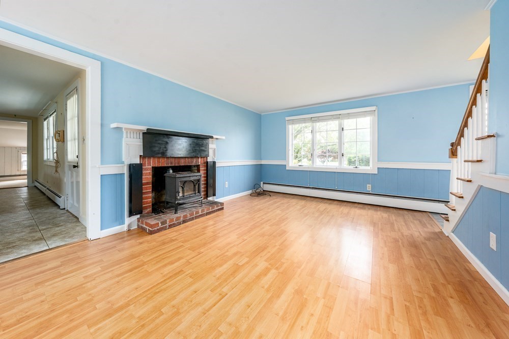 22 Beach View Road Dennis, MA 02670 - Photo 14 of 42 a view of empty room with wooden floor and fireplace