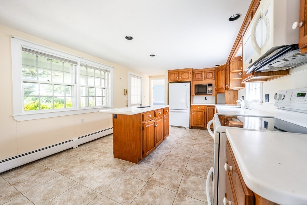 22 Beach View Road Dennis, MA 02670 - Photo 17 of 42 a large white kitchen with a large window