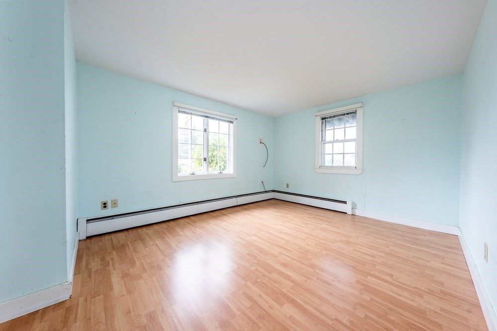 22 Beach View Road Dennis, MA 02670 - Photo 23 of 42 an empty room with wooden floor and windows
