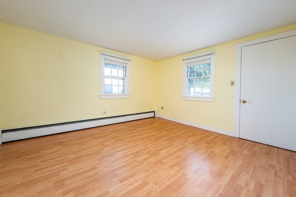22 Beach View Road Dennis, MA 02670 - Photo 25 of 42 a view of an empty room with wooden floor and a window