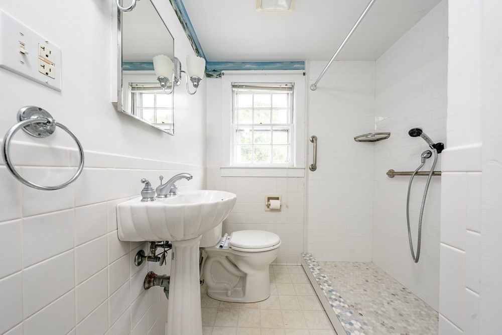 22 Beach View Road Dennis, MA 02670 - Photo 27 of 42 a bathroom with a sink toilet and a mirror