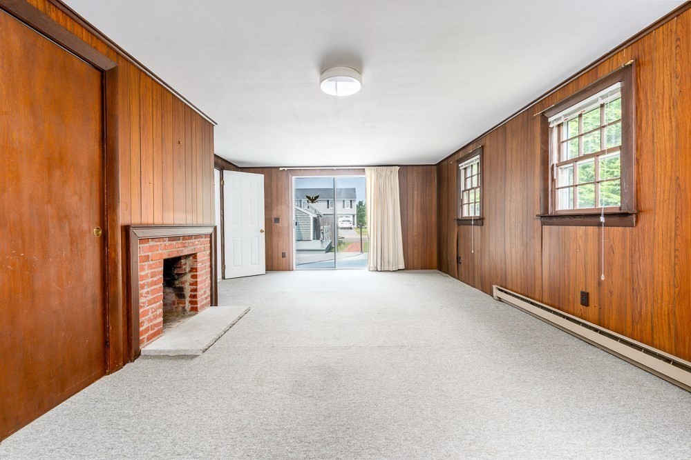 22 Beach View Road Dennis, MA 02670 - Photo 28 of 42 a view of an empty room with a fireplace and a window