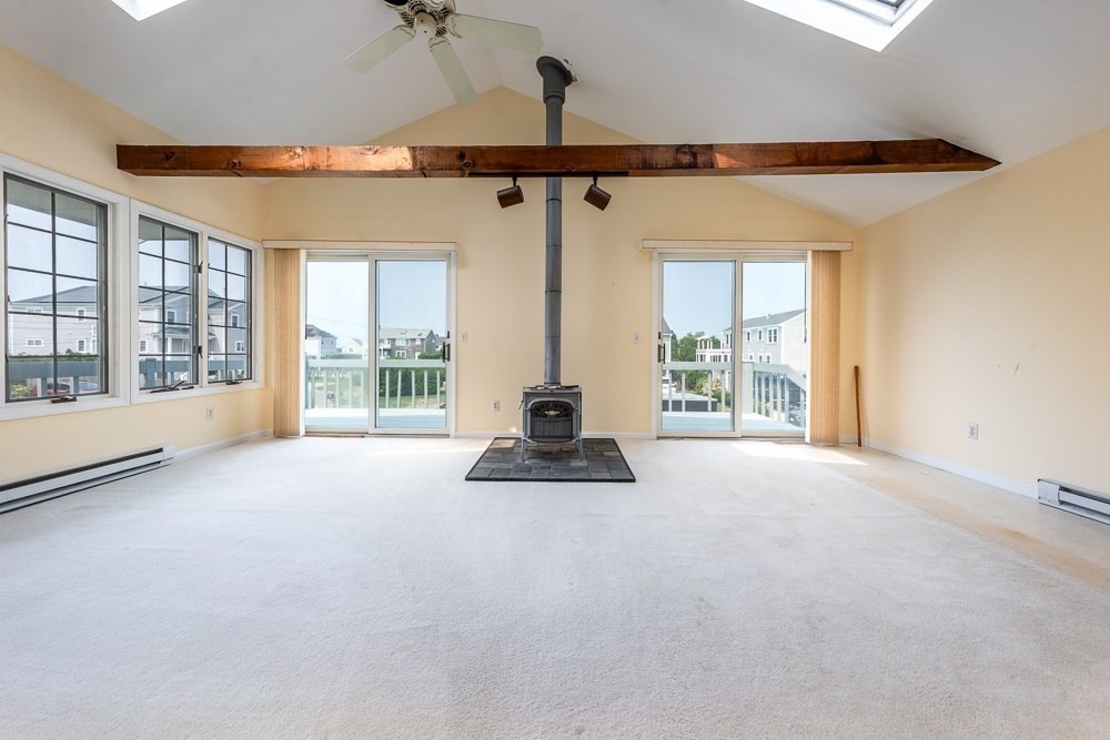 22 Beach View Road Dennis, MA 02670 - Photo 32 of 42 a view of a chandelier and a ceiling fan in a room