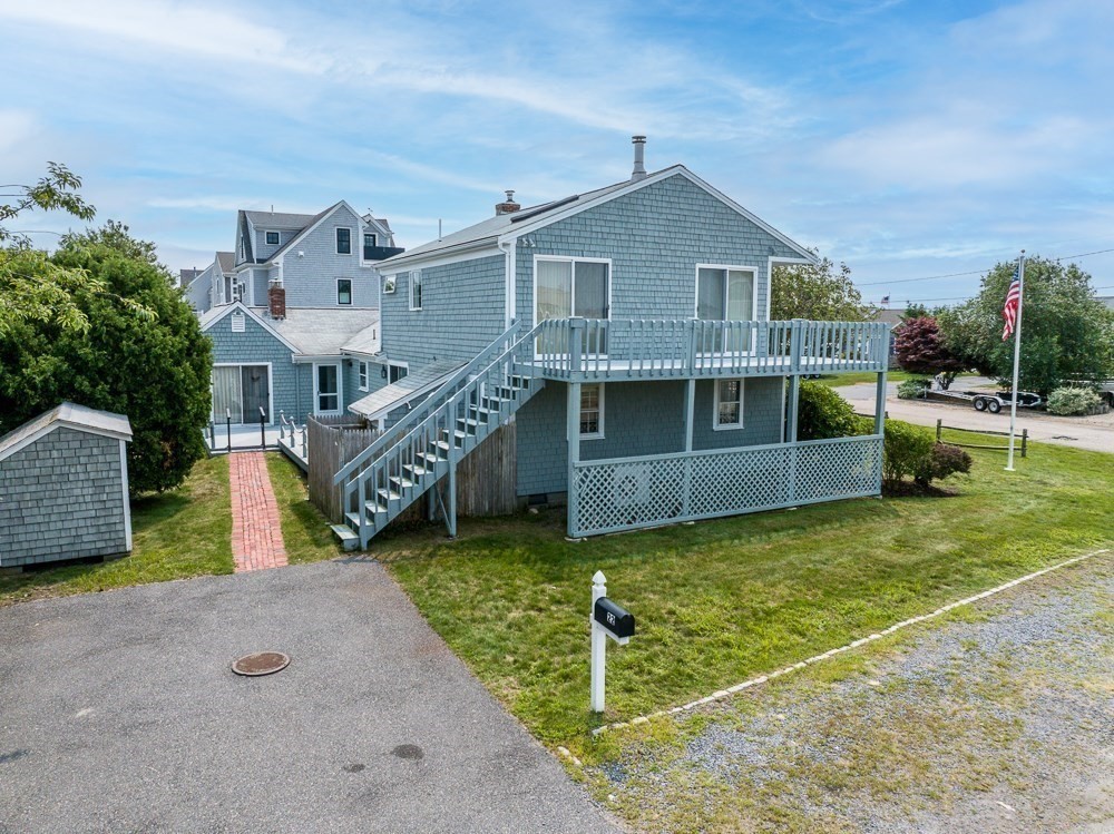 22 Beach View Road Dennis, MA 02670 - Photo 34 of 42 a view of a house with a big yard and large trees