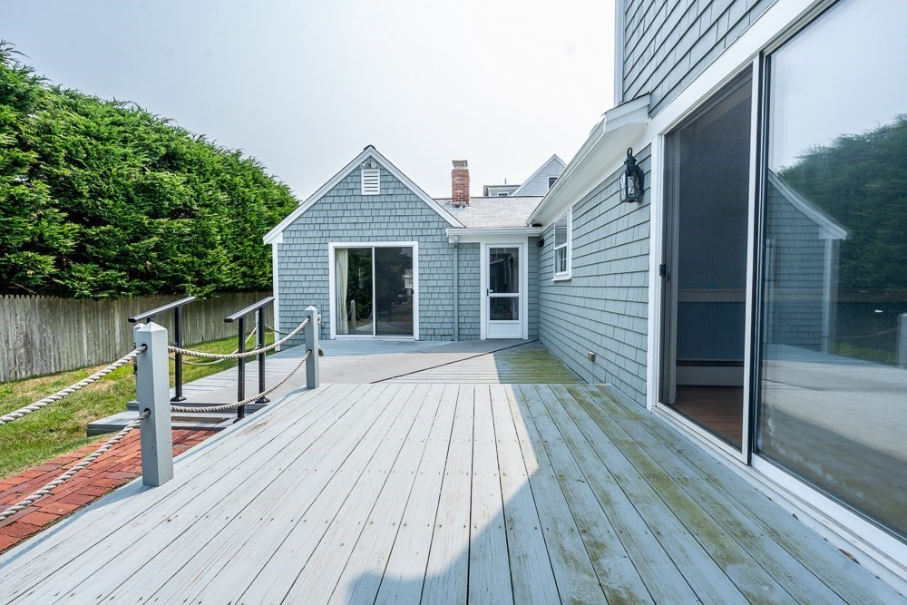 22 Beach View Road Dennis, MA 02670 - Photo 10 of 42 a view of house with deck outdoor seating and yard in the back