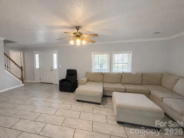 a living room with furniture and a chandelier