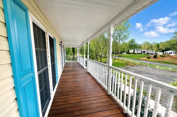 a view of a balcony with wooden floor