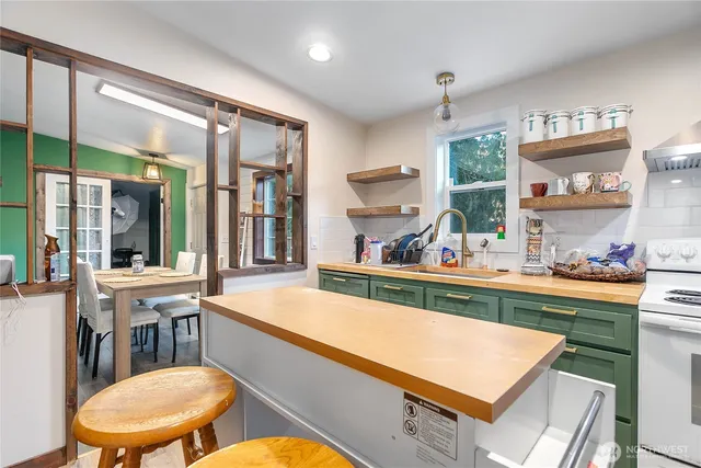 a kitchen with a stove a refrigerator and a dining table