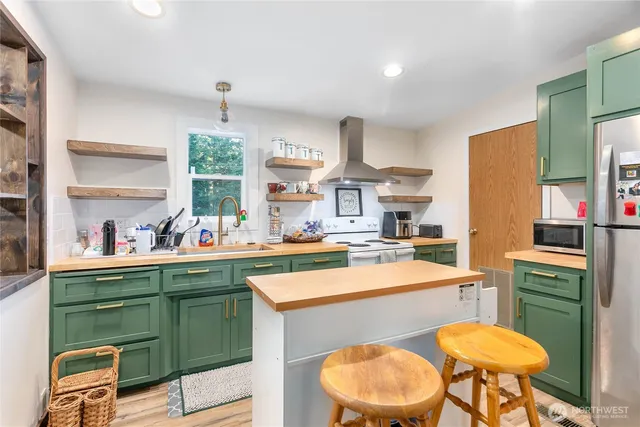 a kitchen with a sink cabinets and wooden floor