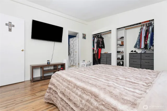 a bedroom with a bed and a flat screen tv