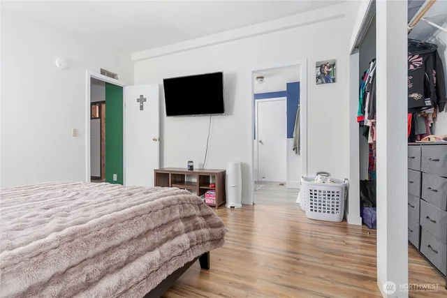 a bedroom with a bed and a flat screen tv