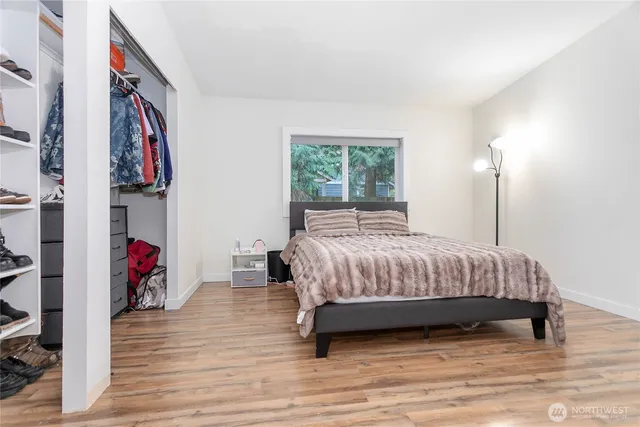 a bedroom with a bed and a flat screen tv