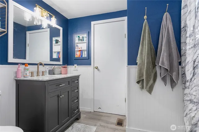 a bathroom with a sink vanity and a mirror